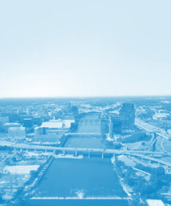 Aerial photograph of the Grand River in downtown Grand Rapids, with a blue filter overlay.