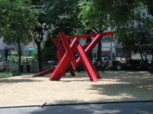 Photograph of art installation (intertwining red, metal bars).