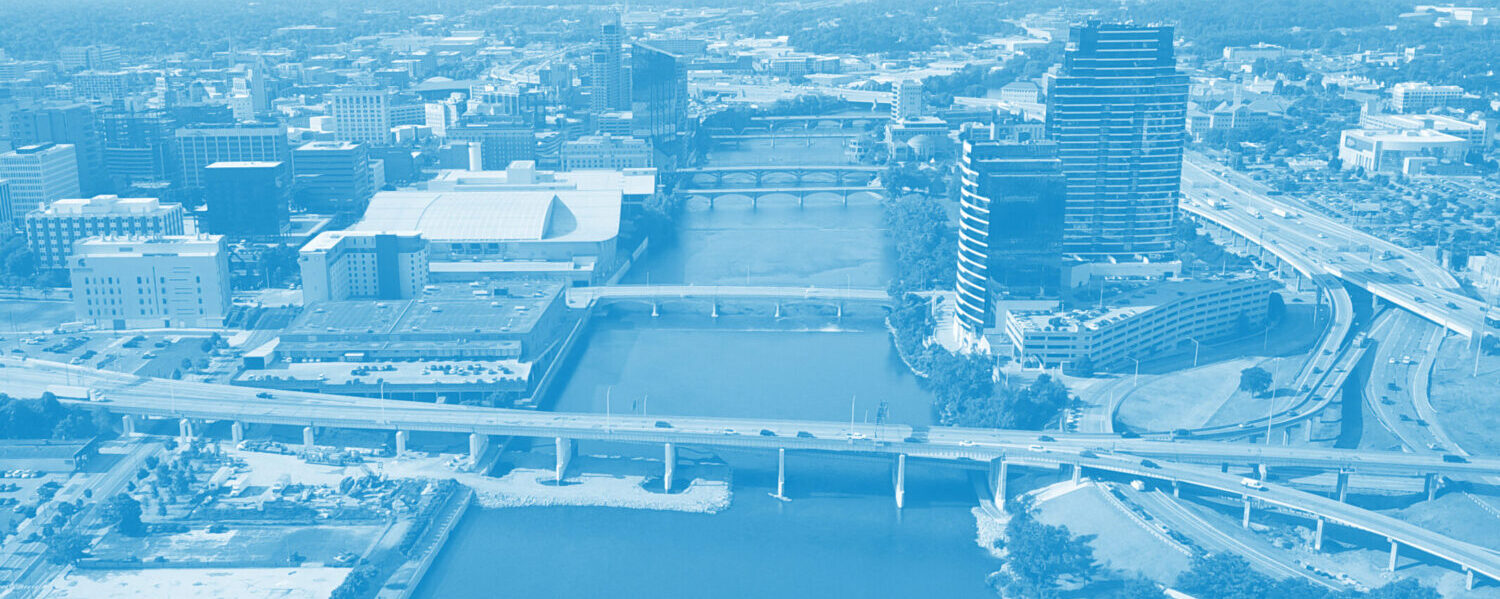 Aerial photograph of the Grand River in downtown Grand Rapids, with a blue filter overlay.