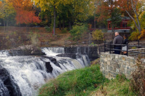 A photograph of a man and woman admiring the Great Falls from the new overlook.