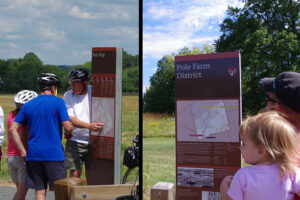 A collage of two images. The left image shows a man with his finger on the overall park map, seeming to discuss with his companions where they will go next. The image on the right shows a man holding a young child looking at the detailed map for the Pole Farm District.